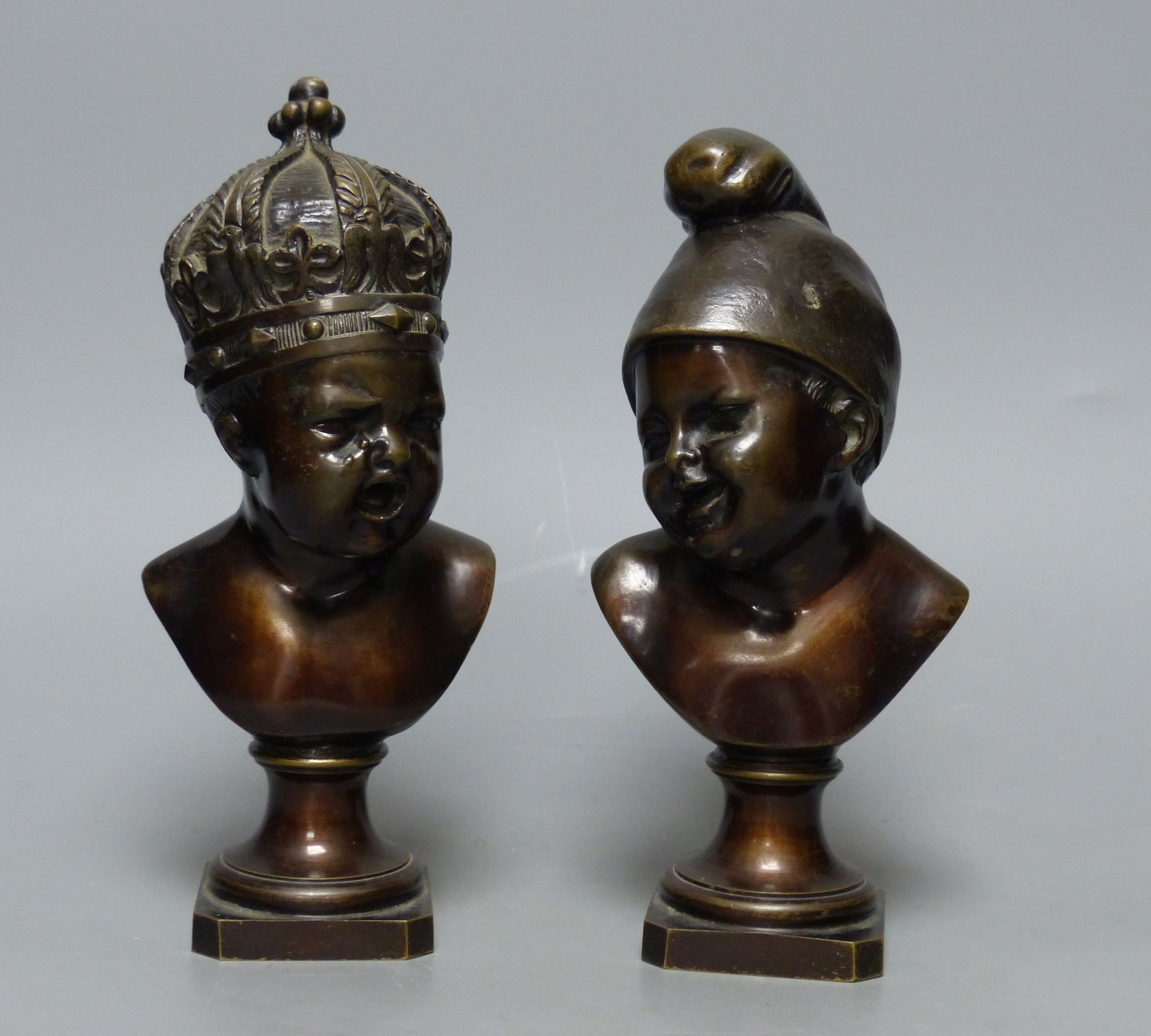 A small bronze bust of a child wearing a crown and another small bronze bust of a child, tallest 22cm H 22cm